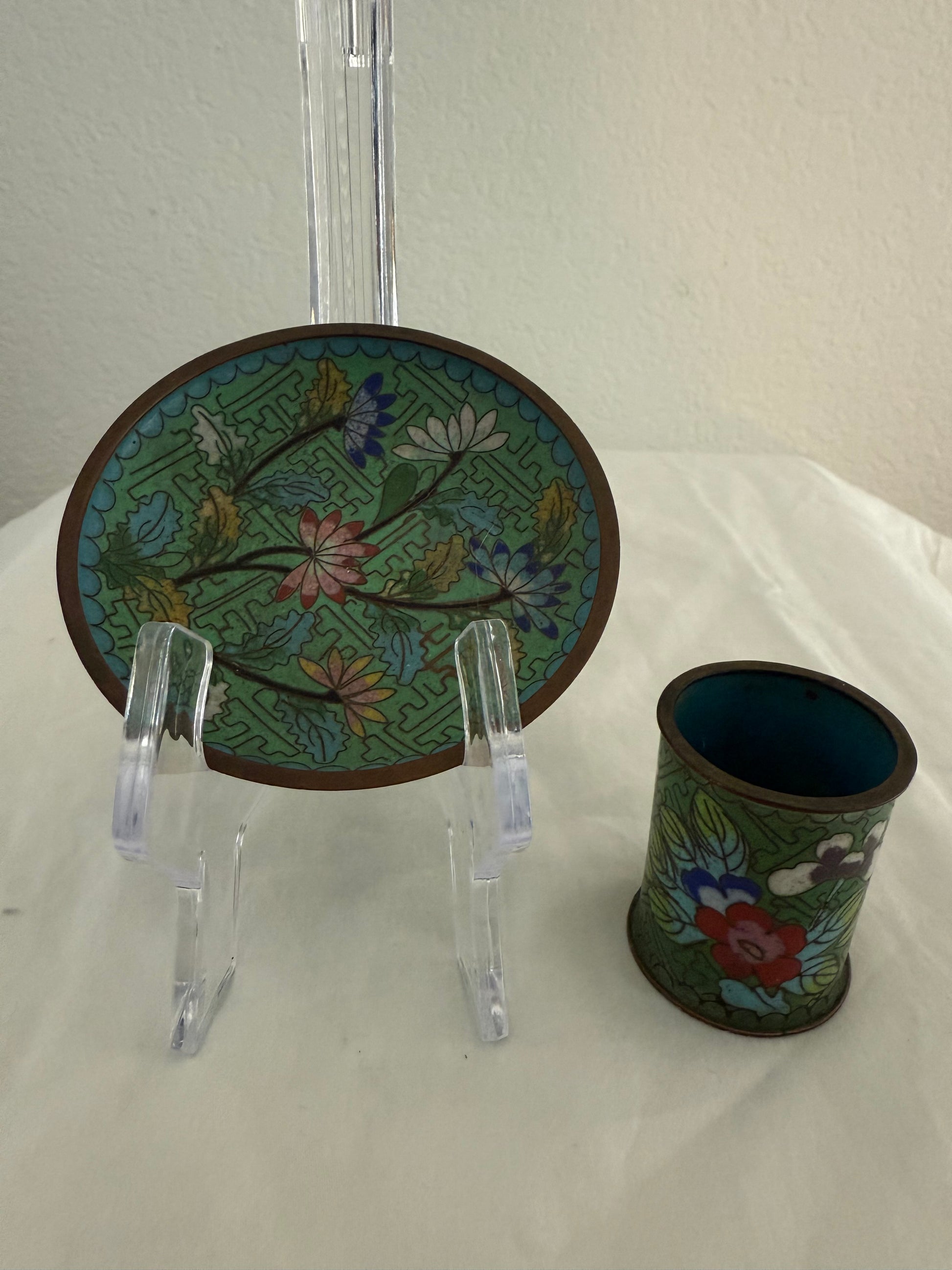 Decorative plate and cup with floral patterns on a white surface