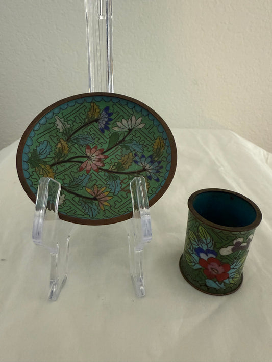 Decorative plate and cup with floral patterns on a white surface