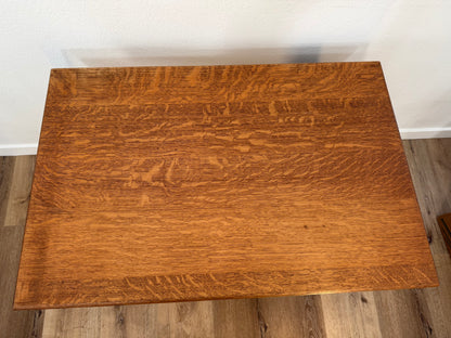 Wooden table with a wavy grain pattern on a wooden floor.