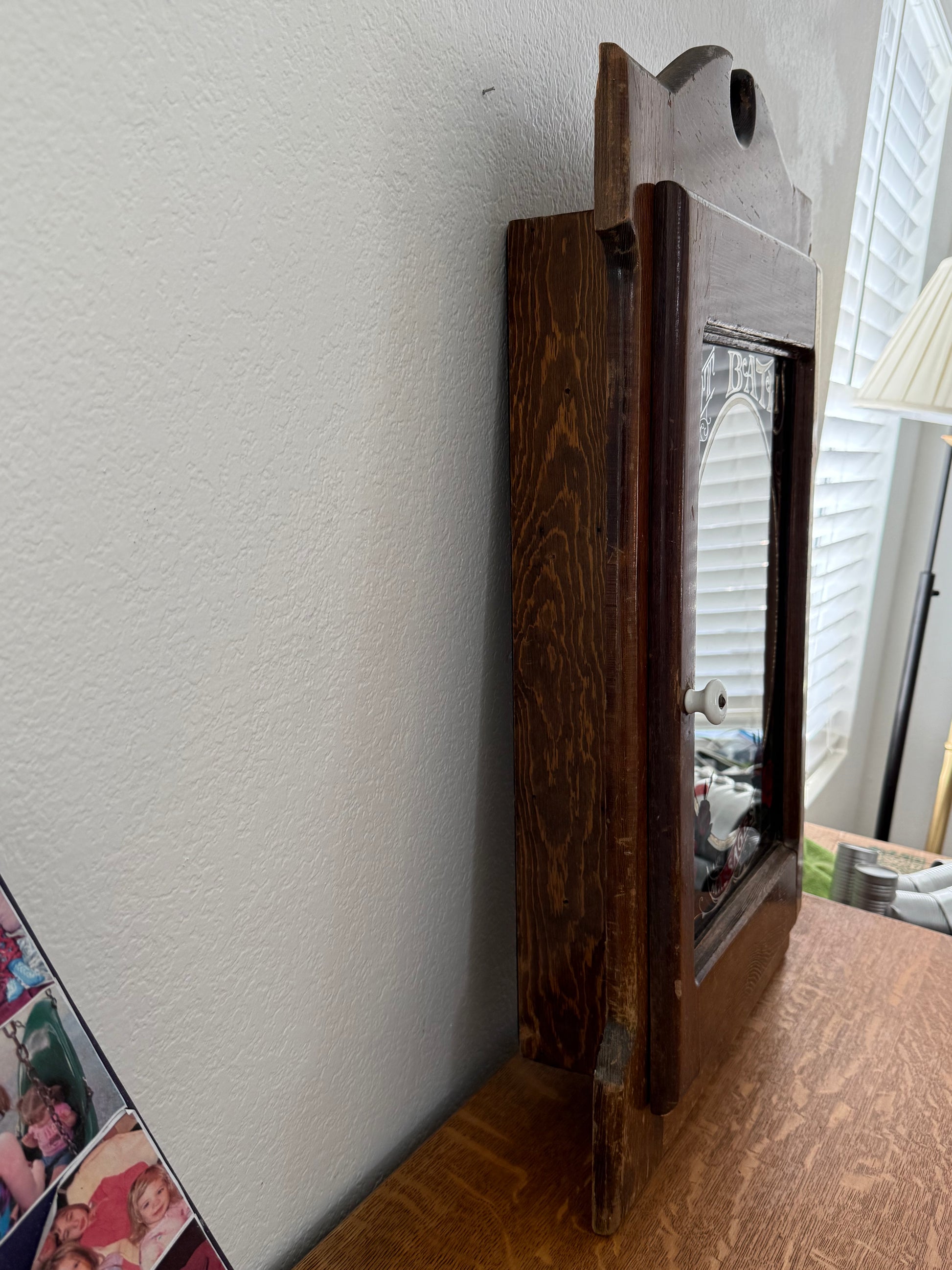 Wooden cabinet on a white surface with a blurred background
