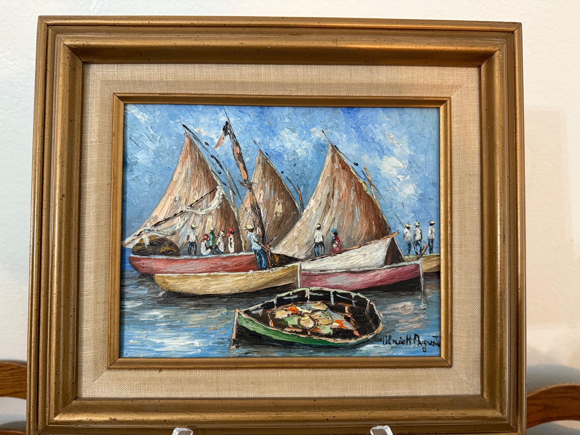 Framed painting of sailboats on a blue sky background