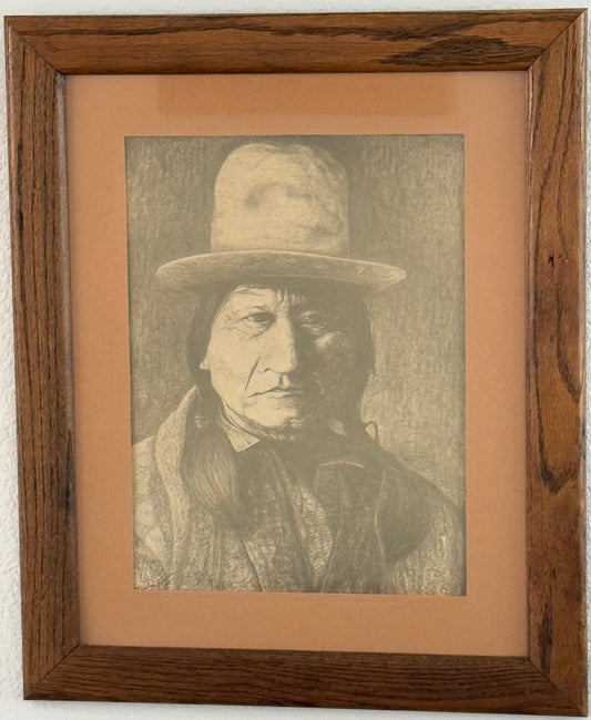 Framed black and white portrait of Sitting Bull wearing a hat on a beige background