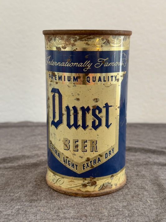 Vintage Durst Beer can on a gray surface