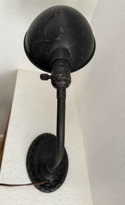 Vintage-style black lamp with a cord on a white background