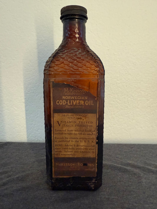 Vintage brown bottle with label on a gray surface