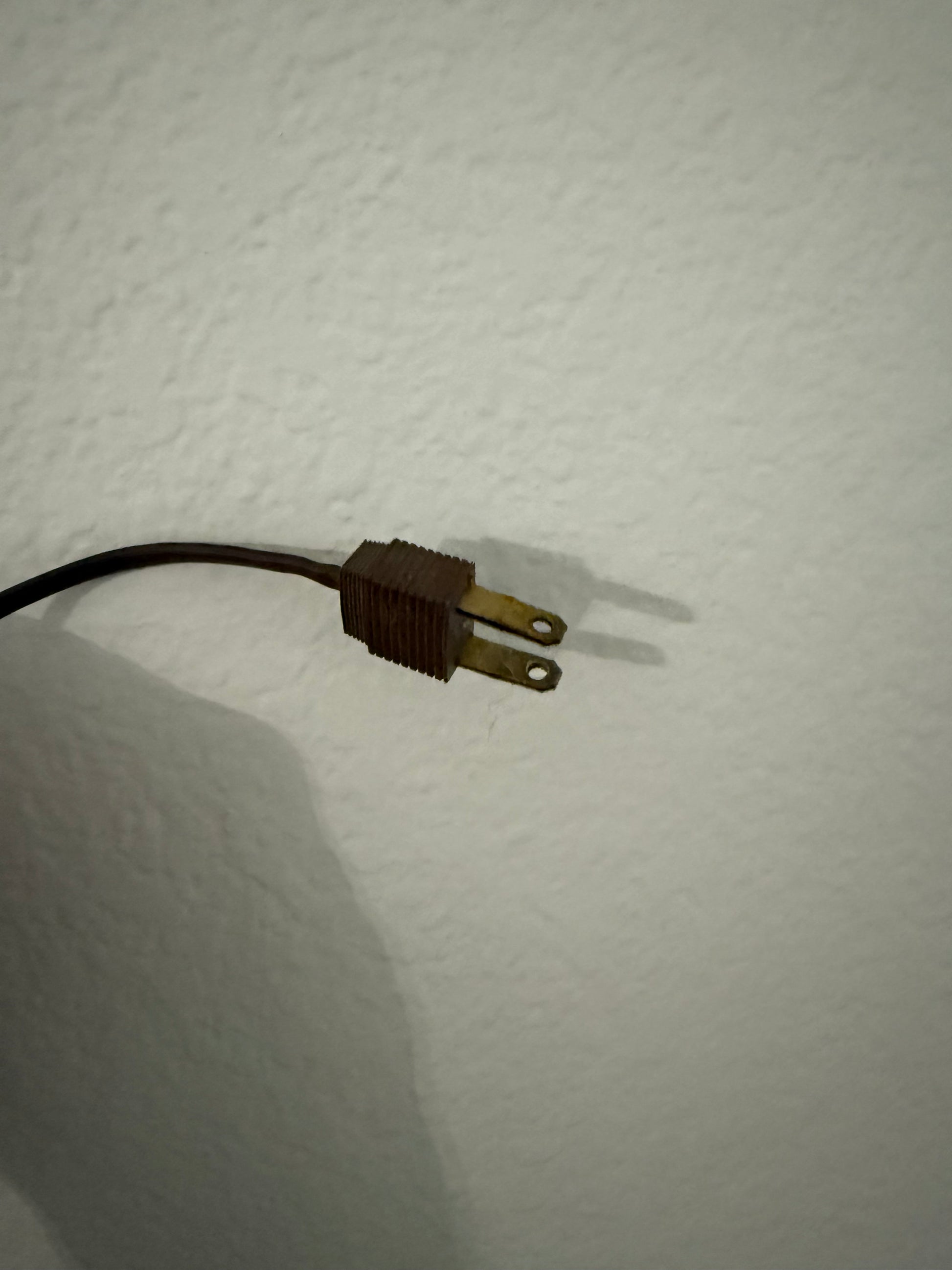 Electrical plug on a white wall
