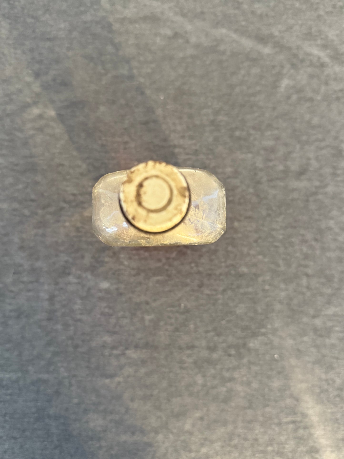 Close-up of a bullet casing on a textured surface