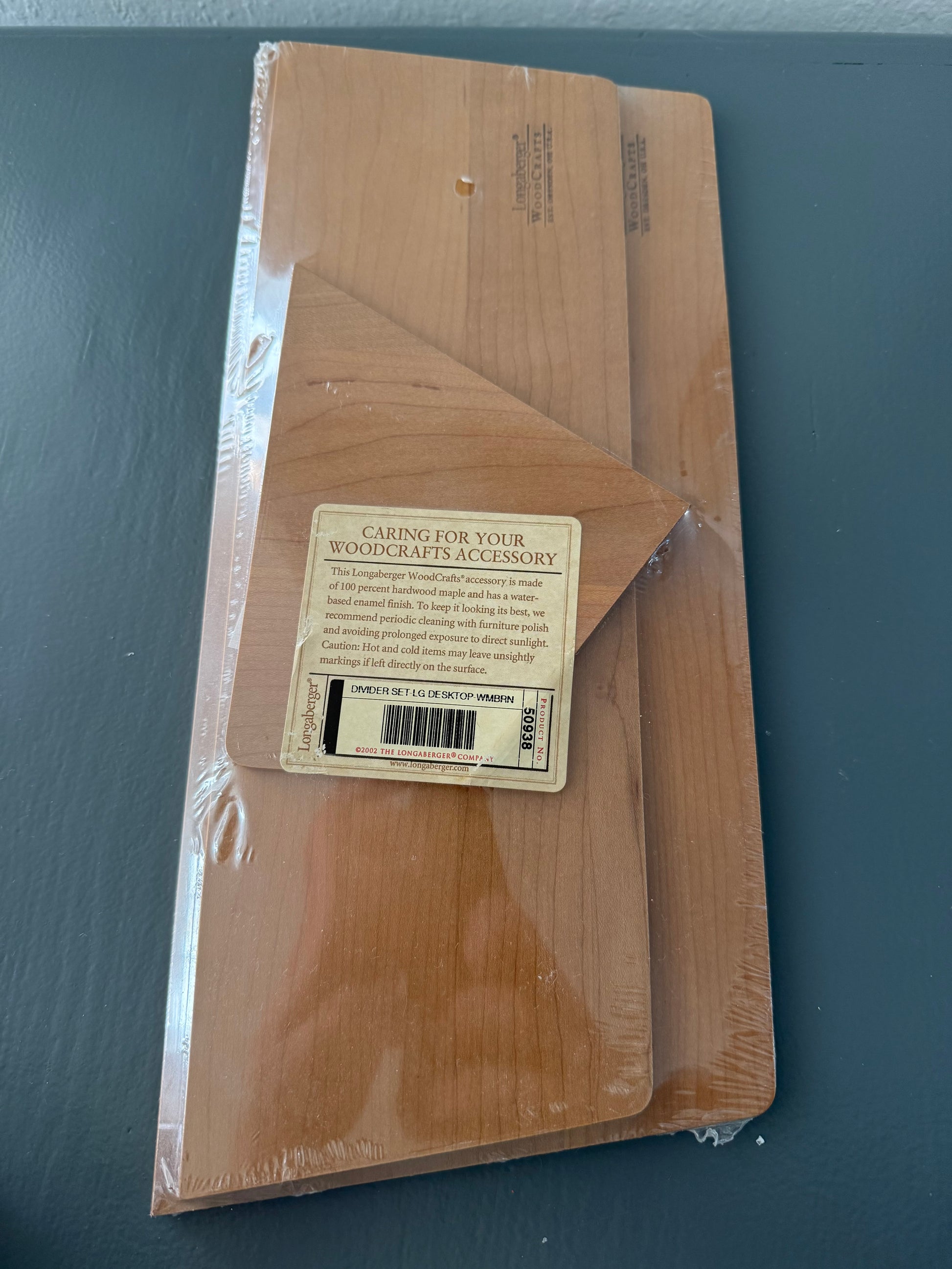 Wooden accessory package with care label on a dark gray background