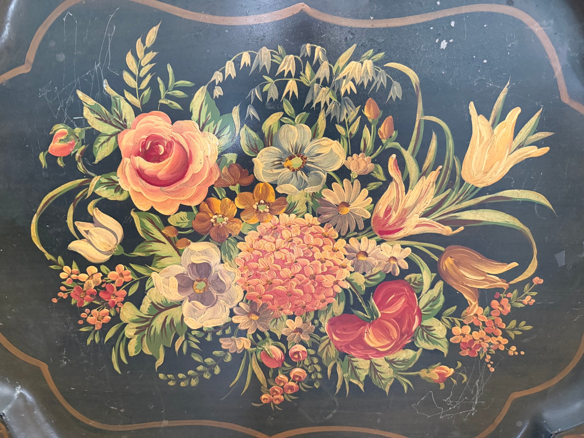 Decorative tray with a floral design on a dark background