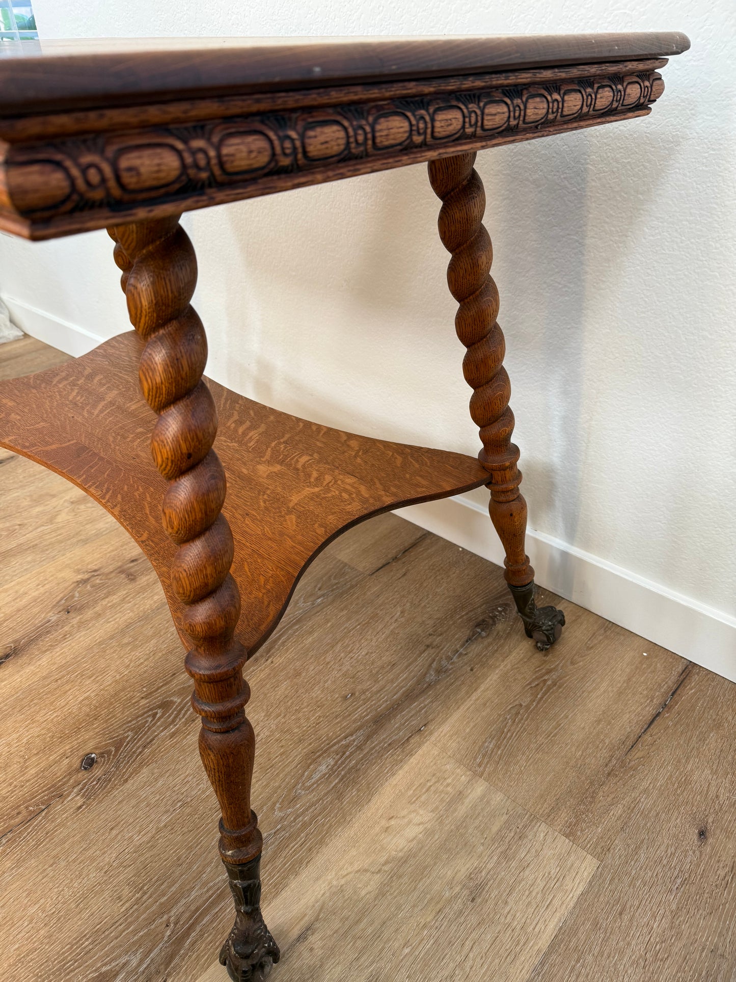 Wooden side table with spiral legs on a wooden floor