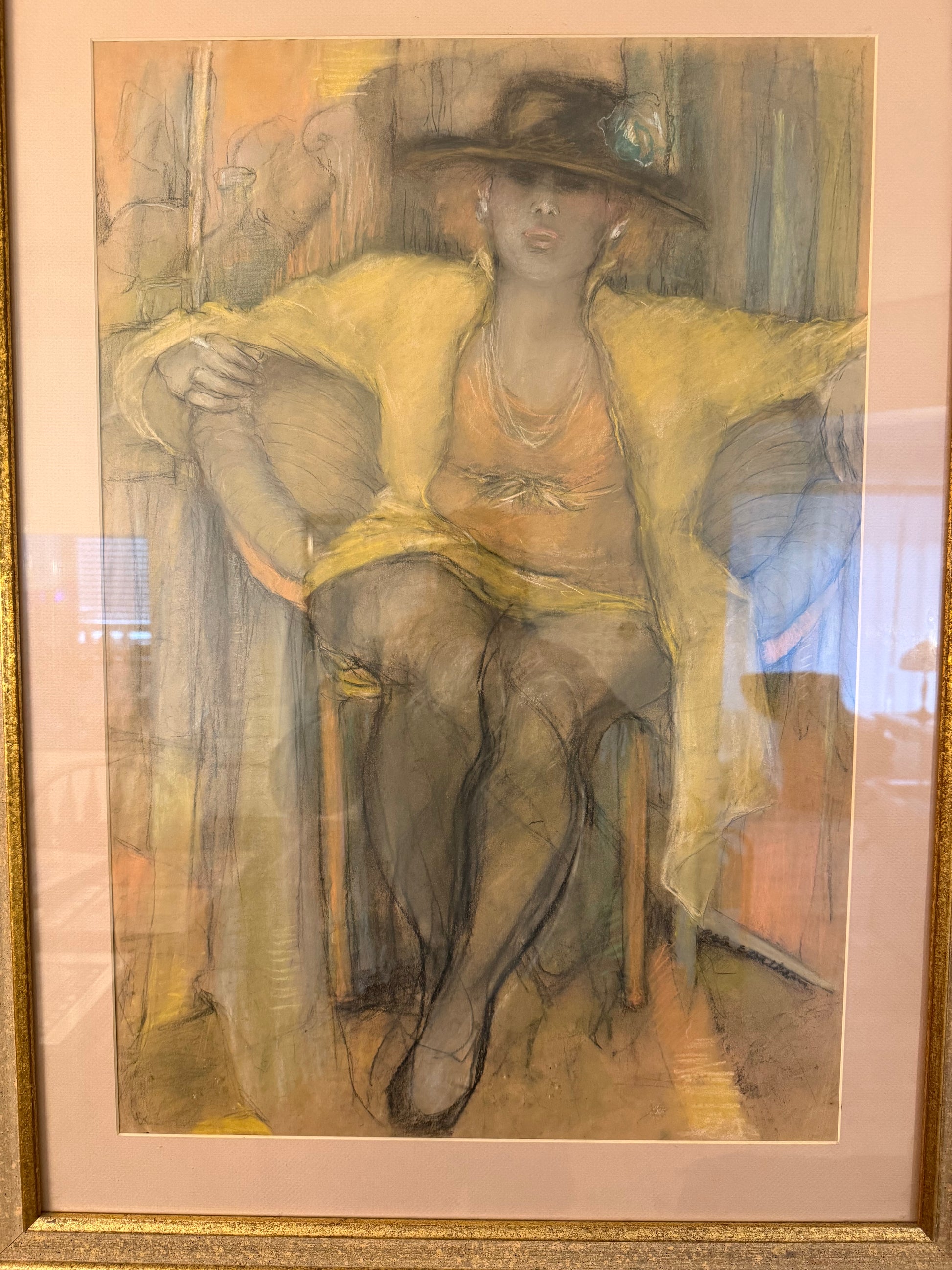 Painting of a woman with a hat in a gold frame
