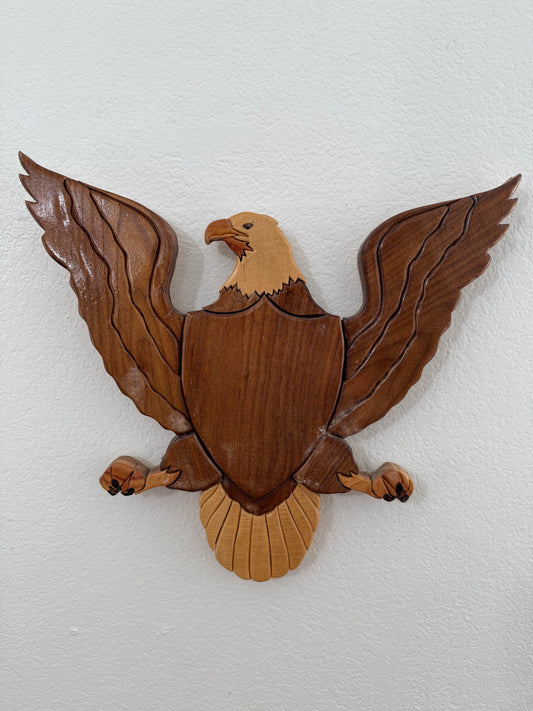 Wooden eagle wall decoration on a white background