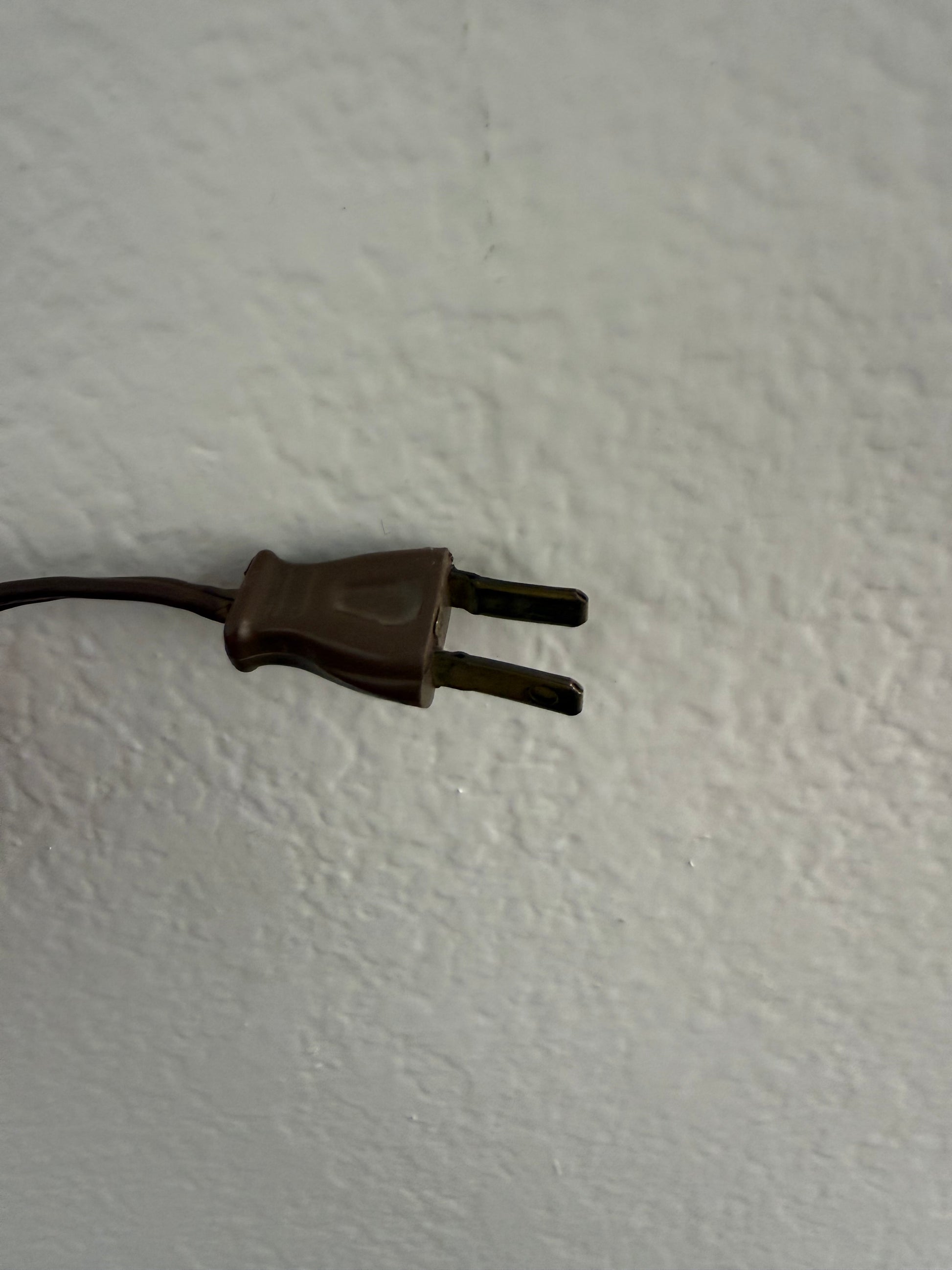 Brown plug on a white wall