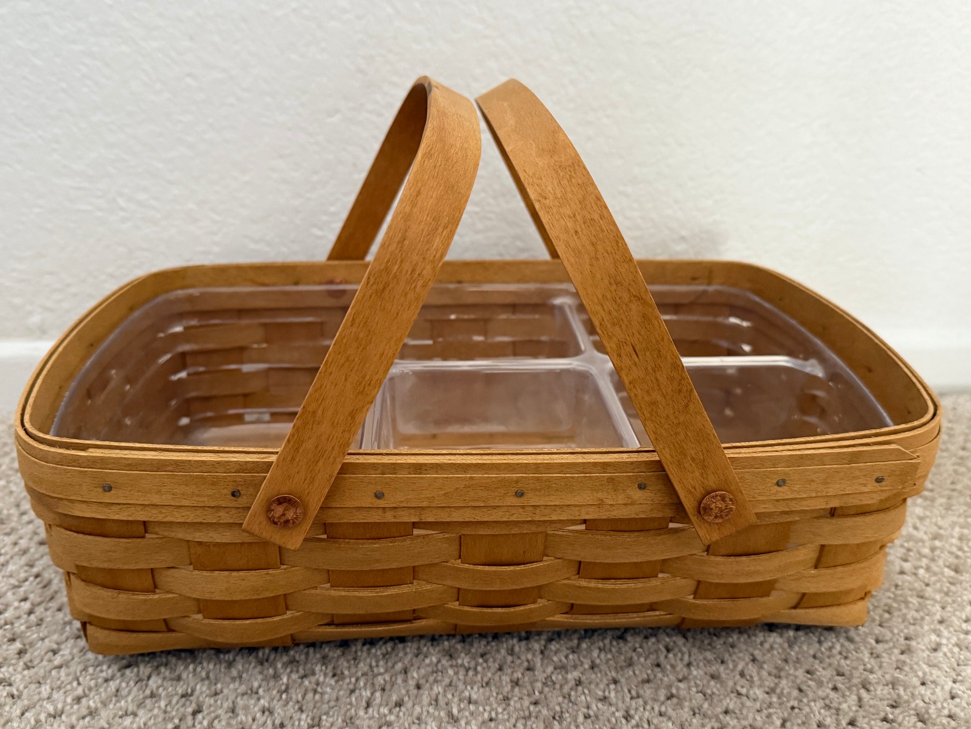 Wooden picnic basket with clear compartments on a white background