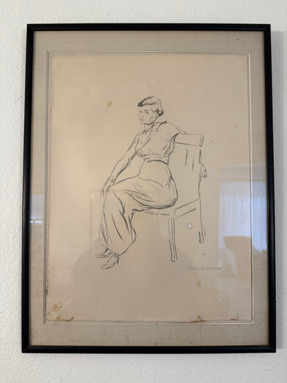 Framed black and white line drawing of a person on a white wall
