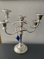 Silver candelabra with 5 candle holders on a gray background