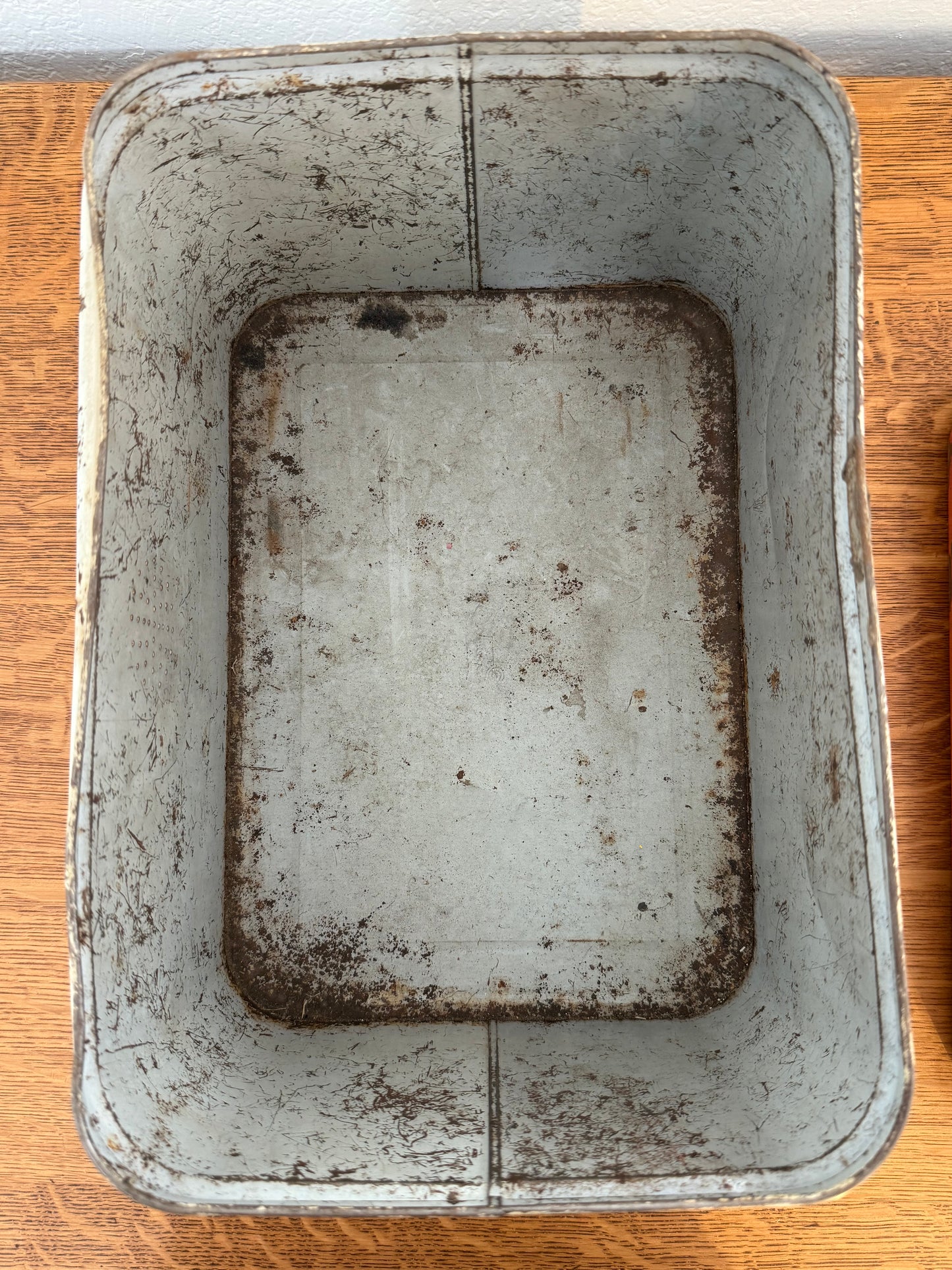 Dirty metal tin on a wooden surface