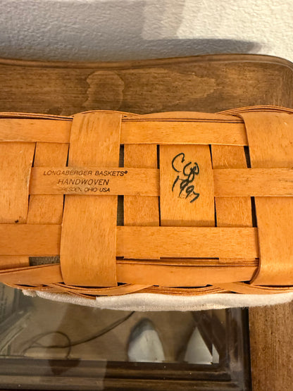 Woven wooden basket with 1997 branding on a white background