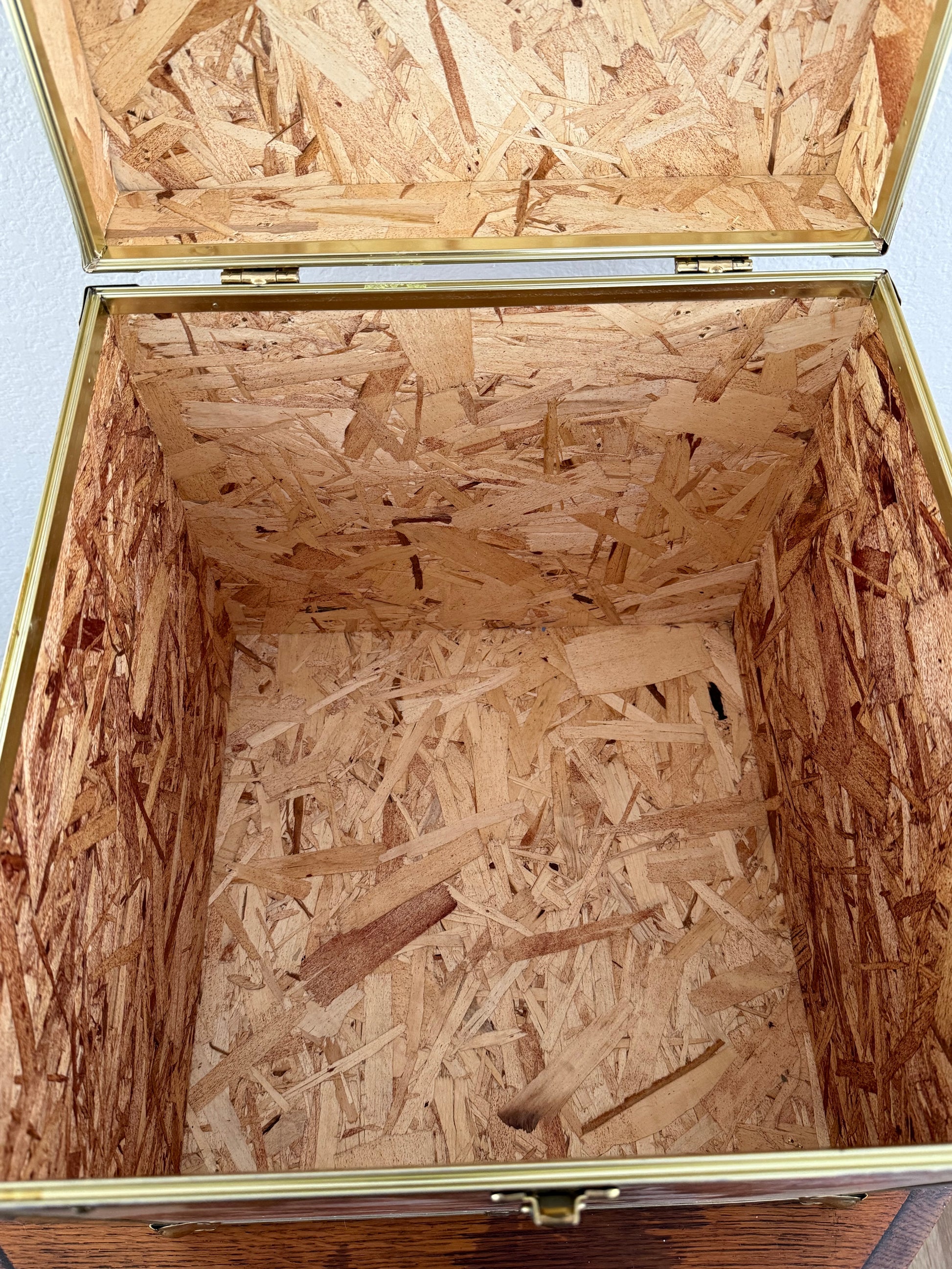 Open wooden box with a view of the interior made of wooden planks.