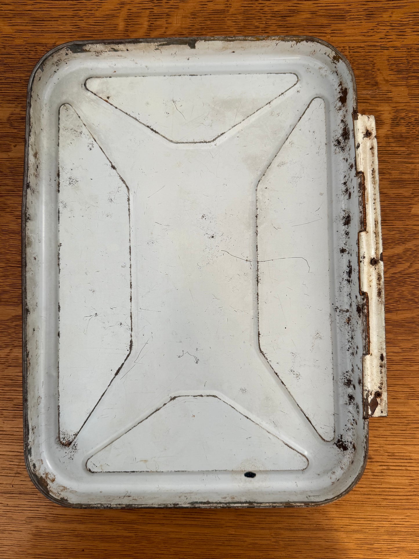 Rust-covered metal tin on a wooden surface