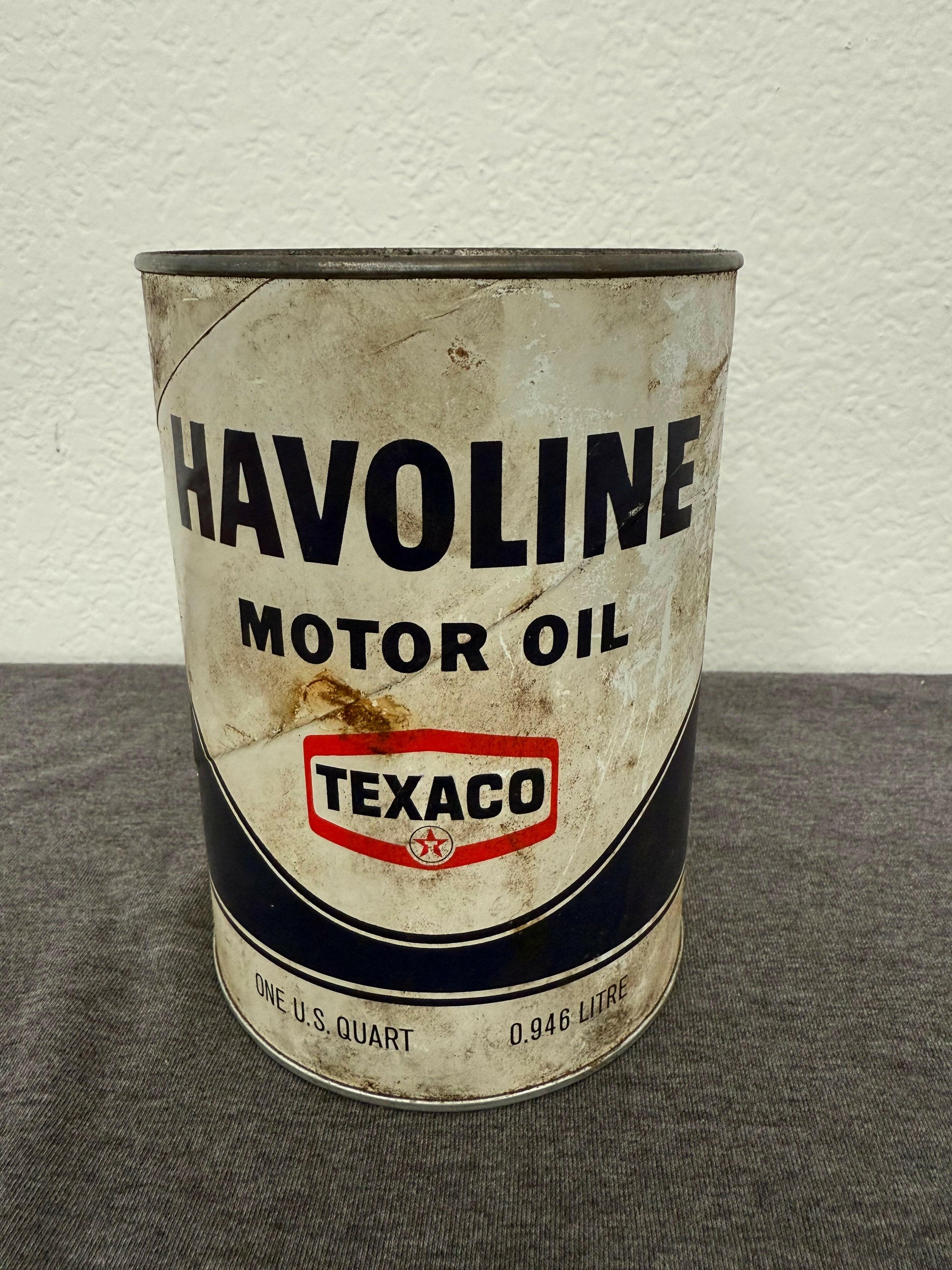 Vintage Havoline motor oil can with Texaco logo on a gray surface.
