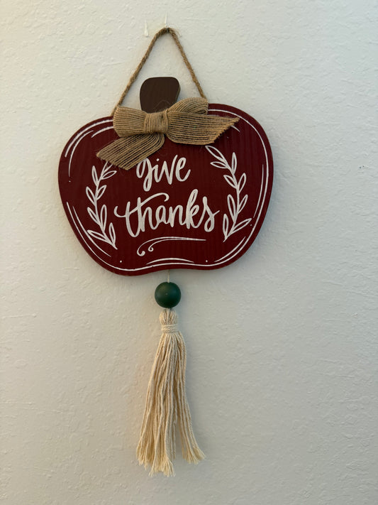 Hanging Pumpkin Shaped Wood Sign with "Give Thanks" Lettering