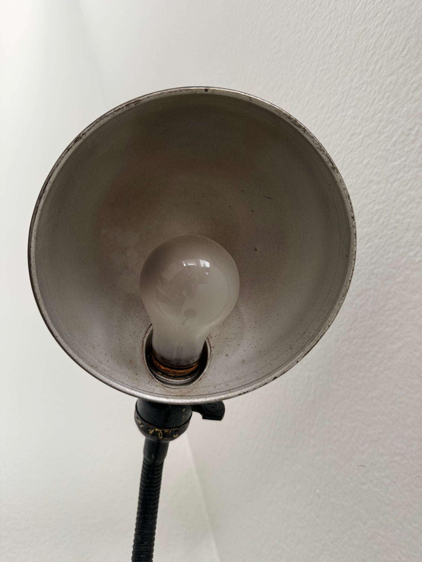 Close-up of a light bulb inside a lampshade against a white background
