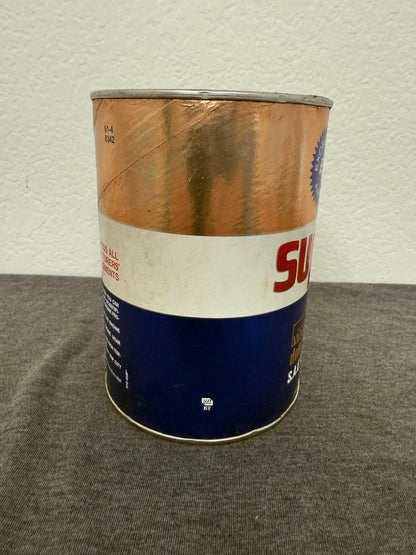 Oil can with a blue label on a textured surface